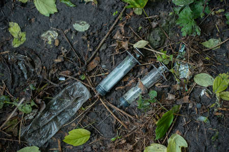 176252754-bunch-of-used-dirty-syringe-leaved-after-drug-injection-lying-on-ground-outdoor